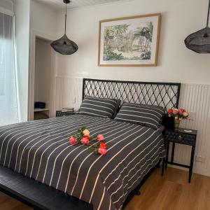 尼尔森湾Ebony & Ivory Villa的一间卧室,床上放着鲜花