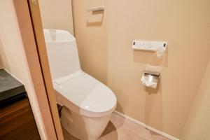 a bathroom with a white toilet in a room at Uhome Fabric Hotel in Tokyo