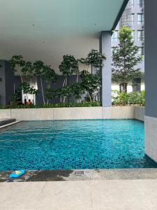 a swimming pool in front of a building at Ruang Hening in Seri Kembangan