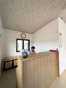 a man is sitting at a counter in a restaurant at Unity Sunrise Resort Statue of Unity Ekta Nagar in Kevadia +24 photos
