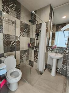 a bathroom with a toilet and a sink at VI Homestay in Miri