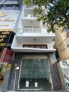 a building with a window with two potted plants in it at Nemaru urban stay in Ho Chi Minh City
