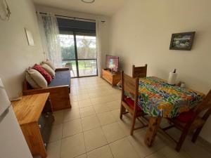 a living room with a table and a dining room at Kalimera Garden in Ma‘yan Barukh