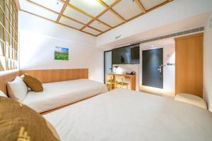 Postel nebo postele na pokoji v ubytování Moonsset INN Taitung