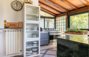 a kitchen with a counter and a clock on the wall at Colmate Pietrasanta - Versilia in Pietrasanta