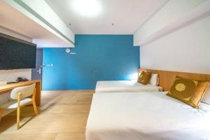 Postel nebo postele na pokoji v ubytování Moonsset INN Taitung