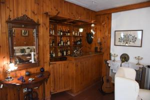 a room with a wooden wall with alcohol bottles at Kiveri Traditional Villa in Kiveri