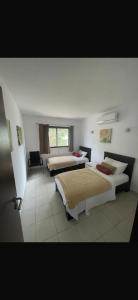 a hotel room with two beds and a window at 3 bedroom/ 3 bathroom villa, Sal, Cape Verde in Santa Maria