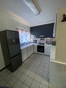 Kuchyň nebo kuchyňský kout v ubytování Ekhaya Manor + 4 fotografie