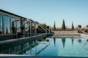 a swimming pool with a slide in front of a building at Manor House, Alsager in Alsager