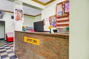 a cash counter with a sign that says spot on at SPOT ON Sri Sai Lohith Lodge Near Secunderabad Railway Station in Hyderabad