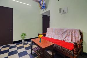 a living room with a couch and a table at SPOT ON Sri Sai Lohith Lodge Near Secunderabad Railway Station in Hyderabad