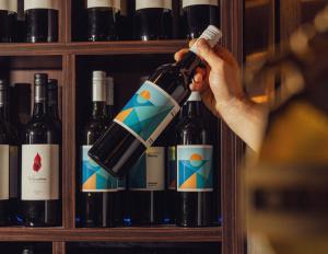 a person is holding a bottle of wine at Glasgow Arms Hotel Ultimo in Sydney