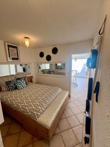 a bedroom with a bed and a door to a patio at Sea Chic - Naturist in Cap d'Agde +6 photos