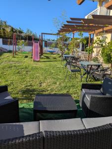 a group of tables and chairs in a yard at Guest House Chalakov in Sinemorets