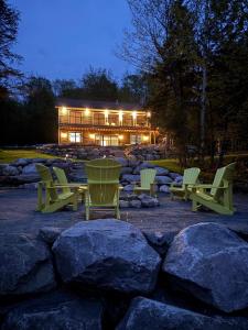 a group of chairs sitting in front of a building at Algonquin Park,Sunset Paradise with Private Beach in Madawaska
