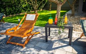 a wooden chair and a table with drinks on it at 4 Bedroom Nice Home In Polaca in Polača