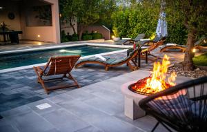 a fire pit with chairs next to a swimming pool at 4 Bedroom Nice Home In Polaca in Polača