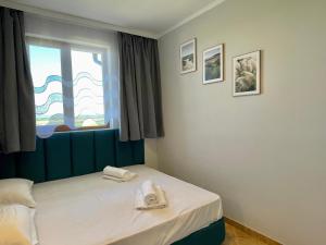 a bedroom with a bed with two towels on it at Arkite - Private apartment - BSR in Sunny Beach