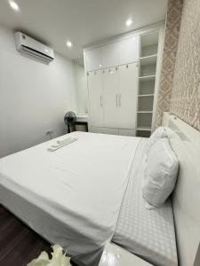 a bedroom with a large white bed and a closet at Homestay NewLife Bãi Cháy in Ha Long
