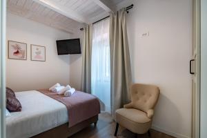 a bedroom with a bed and a chair at Holiday Home 4200-1 for 8 Pers in Lukoran in Lukoran +36 photos