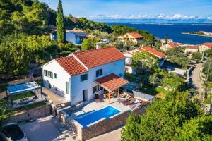 an aerial view of a house with a swimming pool at Holiday Home 4200-1 for 8 Pers in Lukoran in Lukoran