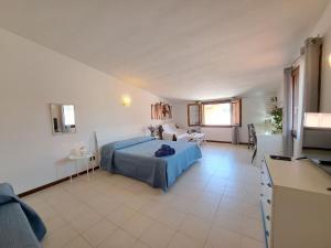 a bedroom with a bed and a living room at I Girasoli Apartment - South Sardinia - Capoterra in Capoterra