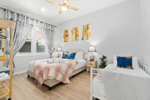 a bedroom with two beds and a window at Stylish 2 Bedroom Unit Close to CBD in Evandale
