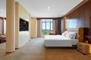Postel nebo postele na pokoji v ubytování May Joys Hotel