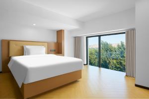 Postel nebo postele na pokoji v ubytování May Joys Hotel