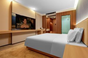 Postel nebo postele na pokoji v ubytování May Joys Hotel