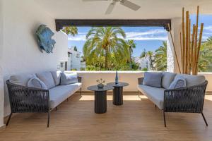 a living room with a couch and a table at Luxurious apartment in Puente Romano, Marbella (Golden Mile) in Marbella
