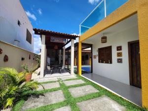 a view of the outside of a house with a patio at Casa Amarela - Santo Amaro in Santo Amaro +39 photos