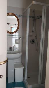 a bathroom with a sink and a shower with a mirror at La Turr De Mezz in Nesso