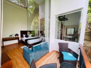 a room with a view of a bathroom with a glass wall at Kavi s Hideaway in Dedugala