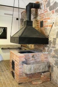 an old brick oven with a black stove at Dubina in Kysibl Kyselka
