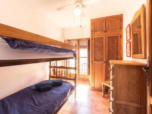 a room with two bunk beds and a cabinet at Casa Lucia in Cozvíjar