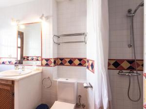 a bathroom with a toilet and a sink and a shower at Casa Lucia in Cozvíjar +32 photos