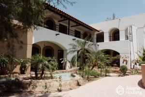 a house with a swimming pool in front of it at 104 Arje Suites Campestre by Alegría Housing in Las Pilas