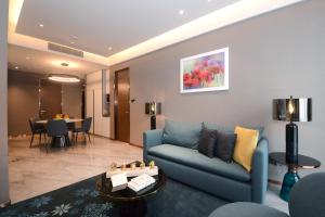 a living room with a couch and a table at Imperial KLCC by Opus Hospitality in Kuala Lumpur