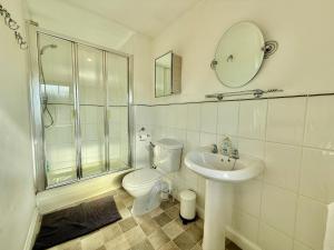 a bathroom with a toilet and a sink and a shower at 5BR 3BA Home Sleeps 10 in Hook in Hook