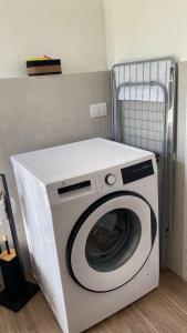 a white washing machine sitting in a room at Little House in Alta Langa in Murazzano