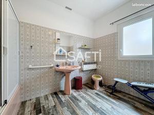 a bathroom with a sink and a toilet at chez l'habitant in Lavelanet +2 photos