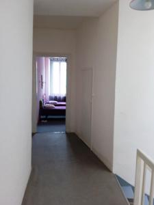 an empty hallway with a couch and a window at chez l'habitant in Lavelanet