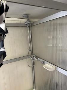 a bathroom with a shower with a sink at Söt stuga in Strömstad