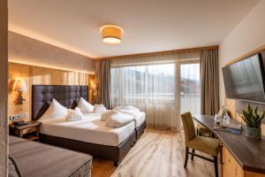 Voodi või voodid majutusasutuse Alpen Glück Hotel Kirchberger Hof toas