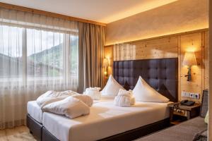 Voodi või voodid majutusasutuse Alpen Glück Hotel Kirchberger Hof toas
