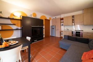 a kitchen and living room with a couch and a table at In suite lake 3 in Pilzone