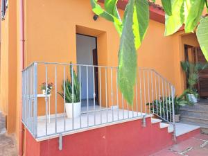 a balcony of a house with potted plants on it at I Girasoli Apartment - South Sardinia - Capoterra in Capoterra