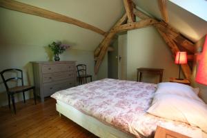 a bedroom with a bed and a dresser and chairs at Domaine de Mousseaux, Montbouy in Montbouy +6 photos